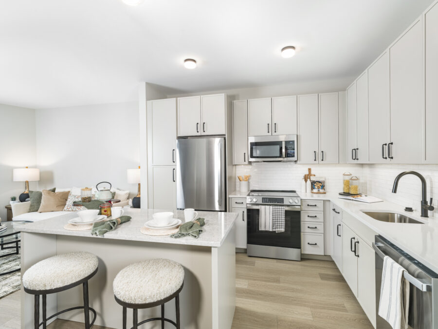 Bright apartment interior showing off kitchen finishes at Modera Falls Church