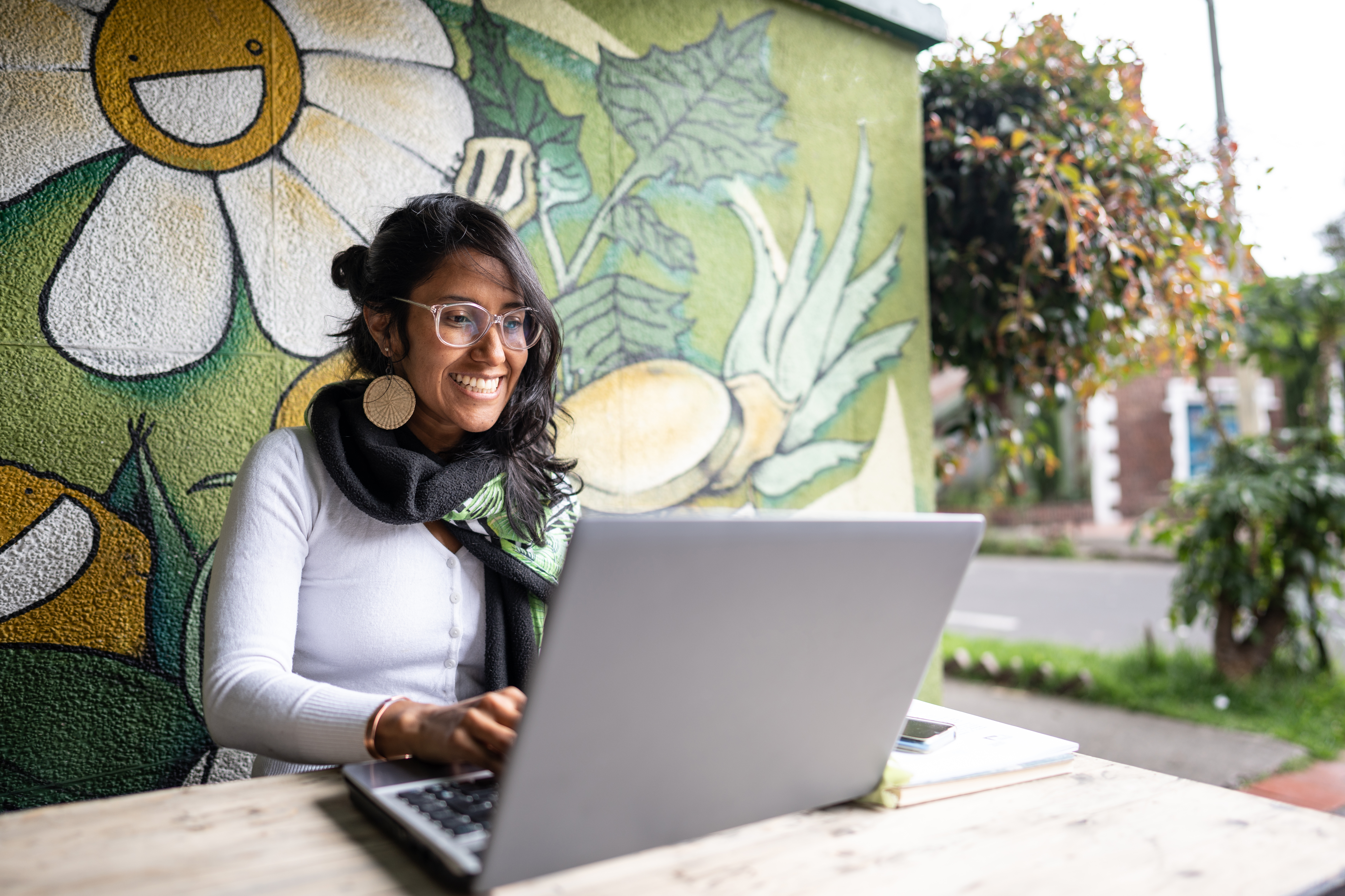 Mid adult woman using a laptop at coffee shop